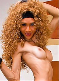 Fishnet clad ladyboy exposing a curly mane of hair